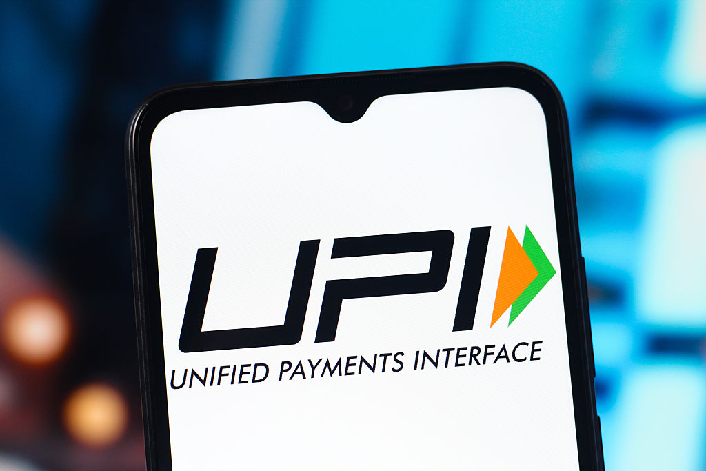 UPI digital payment using a QR code at a small merchant's shop in India.