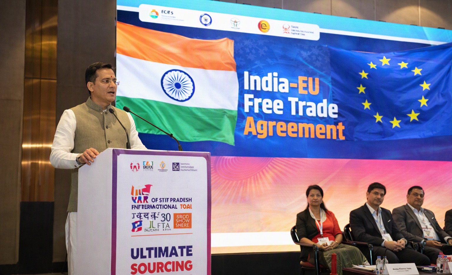 Jitin  Prasada speaking at UP  International  Trade  Show with India and EU flags in background